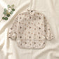 Botanical weaning apron on cream linen — Natural Nursery weaning lifestyle