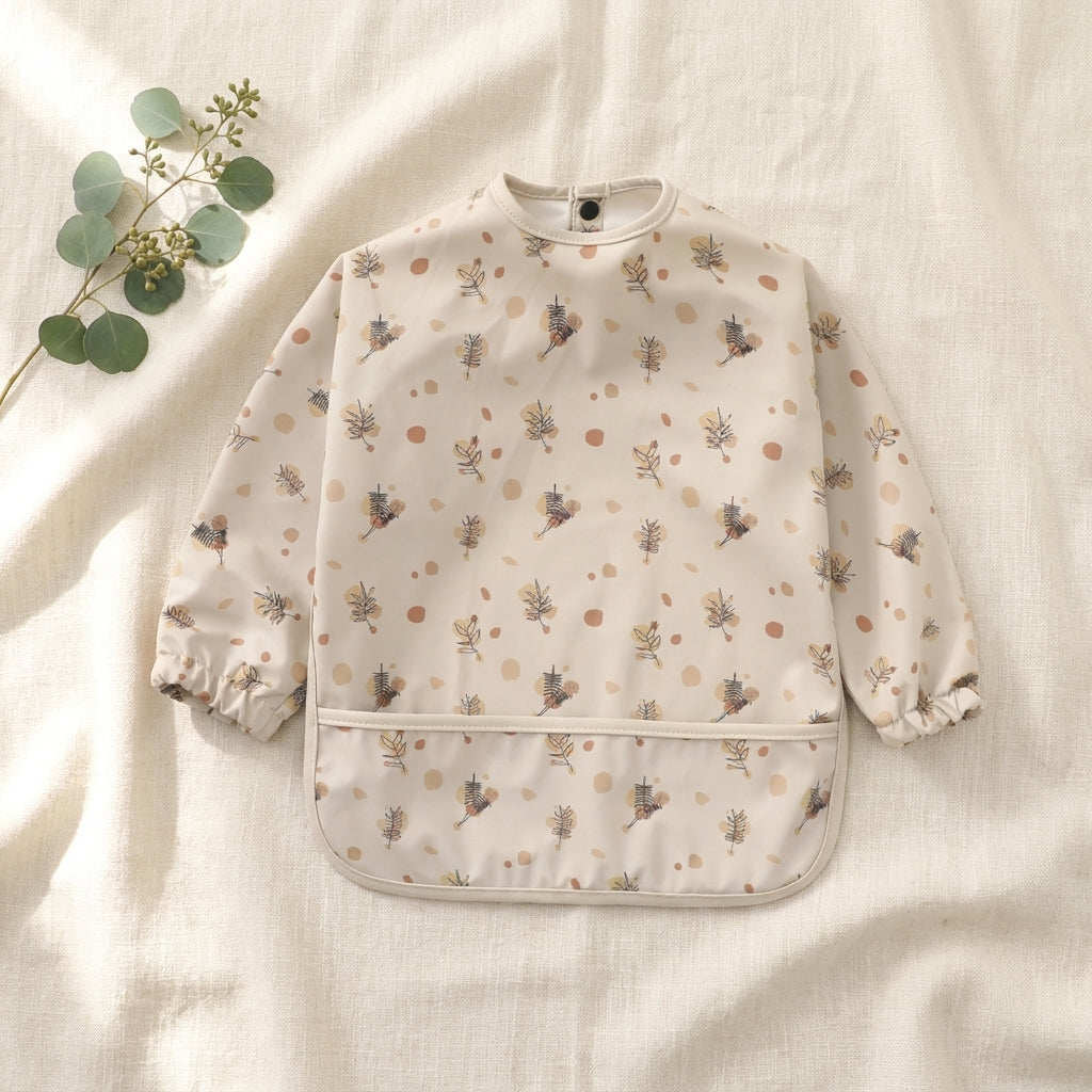 Botanical weaning apron on cream linen — Natural Nursery weaning lifestyle