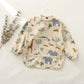 Safari weaning apron on linen — Natural Nursery baby weaning apron