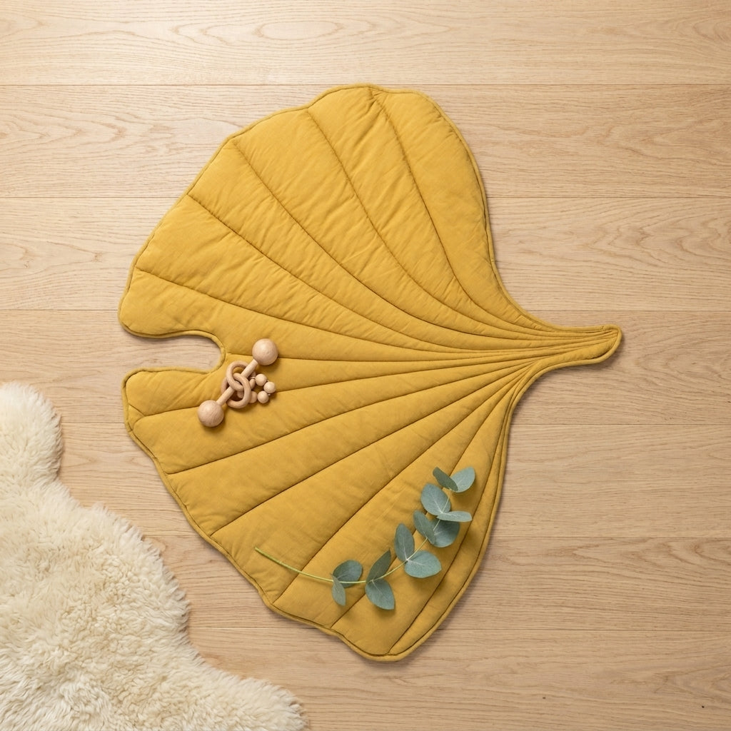 Yellow Leaf playmat flatlay on linen — Natural Nursery tummy time