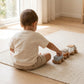 Toddler playing with wooden train — Natural Nursery educational toy